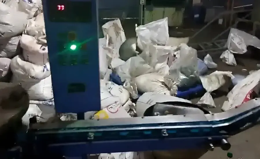 Cap Folding and Slitting Machine close up of tamper-evident ring folding unit